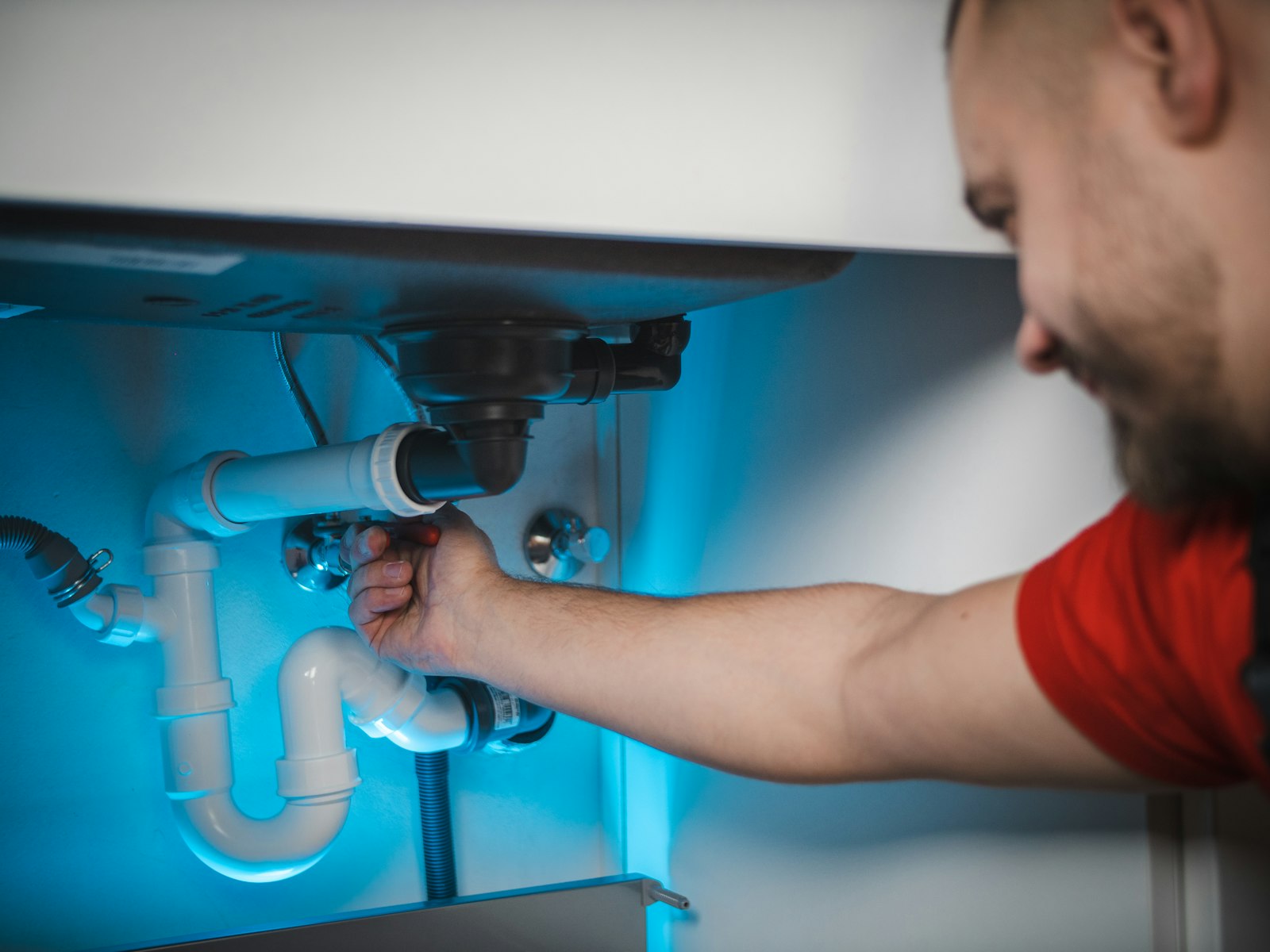 A plumber at work on copper pipework