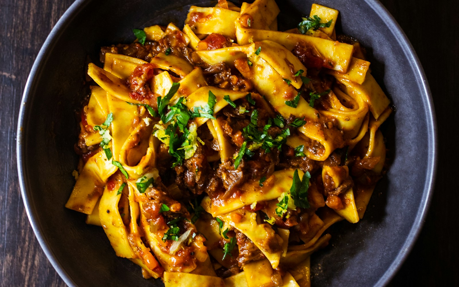 A plated pasta dish on a dark table